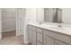 Bright bathroom featuring double vanity with modern fixtures and a glass-enclosed shower at 3142 Hill Point St, Minneola, FL 34715