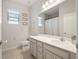 Bathroom featuring a single sink vanity, a toilet, and decoratively framed wall hangings at 3142 Hill Point St, Minneola, FL 34715
