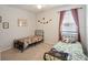 Cozy bedroom with two beds, ceiling fan, natural light, and playful dinosaur decorations at 3142 Hill Point St, Minneola, FL 34715