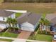 Beautiful home with an attached garage, paver driveway, manicured lawn, and two mature palm trees at 3142 Hill Point St, Minneola, FL 34715