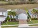 Beautiful single-Gathering home with a well-manicured lawn, a two-car garage, and lovely palm tree accents at 3142 Hill Point St, Minneola, FL 34715