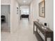 Inviting hallway with neutral tones leading to a spacious living area, showcasing modern decor and ample lighting at 3142 Hill Point St, Minneola, FL 34715