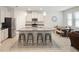 Modern kitchen featuring a large center island with seating, stainless steel appliances, and ample counter space at 3142 Hill Point St, Minneola, FL 34715