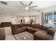 Spacious living room seamlessly connecting to the kitchen and dining area, featuring a large sectional sofa at 3142 Hill Point St, Minneola, FL 34715