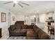 Bright, open living space showcasing a comfortable sectional sofa, leading to a modern kitchen and dining area at 3142 Hill Point St, Minneola, FL 34715