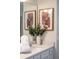 Close-up of a bathroom vanity with marble countertop and decorative plants at 3624 Lily Ln, Davenport, FL 33897