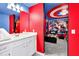 Bathroom and bedroom with red, white, and blue Captain America theme, vanity with white cabinets and marble countertop at 3624 Lily Ln, Davenport, FL 33897