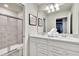 Bright bathroom featuring double sinks, framed mirrors, and a separate shower with glass doors at 3624 Lily Ln, Davenport, FL 33897