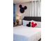 This bedroom features a mural wall and Mickey Mouse decorations, creating a whimsical and themed space at 3624 Lily Ln, Davenport, FL 33897