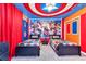 Bedroom with Captain America themed ceiling, Marvel hero artwork, and two twin beds with Marvel bedding at 3624 Lily Ln, Davenport, FL 33897