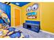 Bright bedroom featuring themed decor, blue accents, and a wall-mounted television for entertainment at 3624 Lily Ln, Davenport, FL 33897