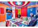Bedroom with a Marvel superhero theme, featuring bunkbeds, colorful accents, and a TV at 3624 Lily Ln, Davenport, FL 33897