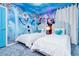 Bright themed bedroom featuring 'Frozen' mural, twin beds, and modern decor at 3624 Lily Ln, Davenport, FL 33897