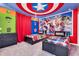 Bedroom featuring a Captain America ceiling, Marvel artwork, and two twin beds with colorful superhero bedding at 3624 Lily Ln, Davenport, FL 33897