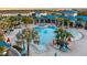 Community pool with surrounding lounge chairs and palm trees for a resort-style living at 3624 Lily Ln, Davenport, FL 33897