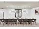 Spacious dining room featuring an extended table, modern chandeliers, and stylish decor at 3624 Lily Ln, Davenport, FL 33897