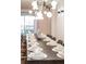Elegant dining area with a long table set for dinner and modern globe lighting at 3624 Lily Ln, Davenport, FL 33897