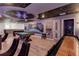 A spacious game room with a pool table, foosball, space themed decor and stylish seating at 3624 Lily Ln, Davenport, FL 33897