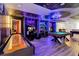 Spacious game room featuring custom themed decor, multiple entertainment options, and stylish, modern design at 3624 Lily Ln, Davenport, FL 33897