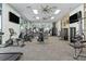 Modern gym with cardio machines, weight-lifting equipment, ceiling fans and large windows at 3624 Lily Ln, Davenport, FL 33897