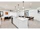 Modern kitchen featuring stainless steel appliances, white cabinets, and a spacious island with seating at 3624 Lily Ln, Davenport, FL 33897