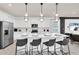Bright kitchen featuring a white island with barstool seating and modern pendant lighting at 3624 Lily Ln, Davenport, FL 33897