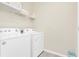 Neat laundry room with side by side washer and dryer at 3624 Lily Ln, Davenport, FL 33897