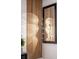 Detail shot of a modern light fixture and wooden wall decor in the living room at 3624 Lily Ln, Davenport, FL 33897