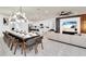 Open-concept living space with dining area, kitchen, and comfortable seating arrangement at 3624 Lily Ln, Davenport, FL 33897