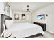 This main bedroom offers a tranquil retreat, complete with a sleek dresser and a modern chandelier at 3624 Lily Ln, Davenport, FL 33897