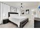 Beautifully staged main bedroom with a large bed, modern lighting and art at 3624 Lily Ln, Davenport, FL 33897