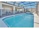 Screened-in outdoor pool, hot tub, lounge chairs, grill, and dining area, perfect for Florida living at 3624 Lily Ln, Davenport, FL 33897