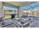 This outdoor living space is great for grilling and entertaining with seating that overlooks a screened-in pool at 3624 Lily Ln, Davenport, FL 33897