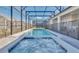 Sparkling pool and relaxing hot tub within a screened enclosure, perfect for outdoor enjoyment at 3624 Lily Ln, Davenport, FL 33897