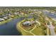 Aerial of a community area with a pool, playground, and lake with a fountain at 3840 Wood Thrush Dr, Kissimmee, FL 34744