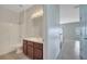 Bathroom featuring a shower-tub combo, vanity, and a modern lighting fixture at 3840 Wood Thrush Dr, Kissimmee, FL 34744