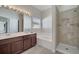Bathroom featuring a double sink vanity, soaking tub, and walk-in shower at 3840 Wood Thrush Dr, Kissimmee, FL 34744