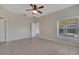 Bright bedroom featuring tile flooring, a ceiling fan, and a large window at 3840 Wood Thrush Dr, Kissimmee, FL 34744