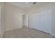 Bedroom with vaulted ceilings, tile floors, and double door closet for storage at 3840 Wood Thrush Dr, Kissimmee, FL 34744