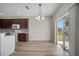 Dining area with wood flooring, chandelier, and sliding glass doors to the backyard at 3840 Wood Thrush Dr, Kissimmee, FL 34744