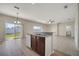 An open floorplan connects the kitchen with granite counters and stainless appliances to the living area at 3840 Wood Thrush Dr, Kissimmee, FL 34744