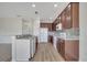 Kitchen boasts stainless appliances, dark wood cabinets, and granite countertops at 3840 Wood Thrush Dr, Kissimmee, FL 34744