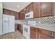 Well-equipped kitchen with stainless steel appliances, granite countertops, and wooden cabinetry at 3840 Wood Thrush Dr, Kissimmee, FL 34744