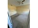 An empty bedroom featuring neutral carpet and yellow paint; awaiting your personal touch to transform the space at 404 Banyon Tree Cir # 202, Maitland, FL 32751