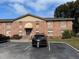 A cozy apartment building with well-maintained landscaping, a parking lot, and charming architectural details at 404 Banyon Tree Cir # 202, Maitland, FL 32751