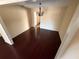 A bright dining room featuring hardwood floors and a modern chandelier; inviting space for entertaining at 404 Banyon Tree Cir # 202, Maitland, FL 32751