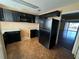 Traditional kitchen features black appliances, cabinets, light countertops and a view of the living area at 404 Banyon Tree Cir # 202, Maitland, FL 32751