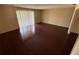 Bright living room featuring sleek, dark-toned hardwood floors and large windows with bright natural light at 404 Banyon Tree Cir # 202, Maitland, FL 32751