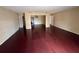 Open-concept living room showcasing pristine hardwood floors, seamless transitions, and abundant natural light at 404 Banyon Tree Cir # 202, Maitland, FL 32751
