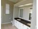 Bathroom featuring double vanity sinks, neutral tile floors, and recessed lighting at 409 Lytton Cir, Orlando, FL 32824